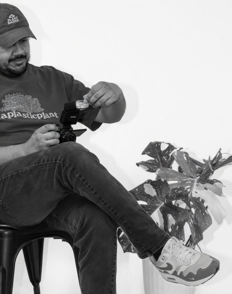 Lazaro seated with his camera and studio flash